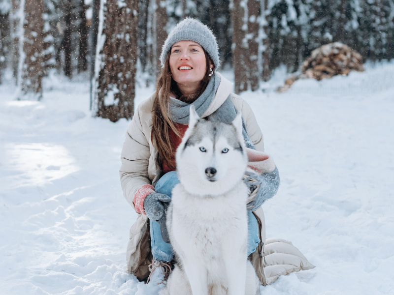 young woman with husky dog in winter