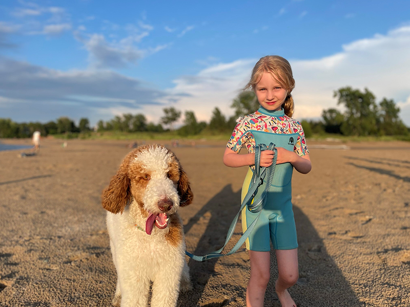 girl on beach with dog