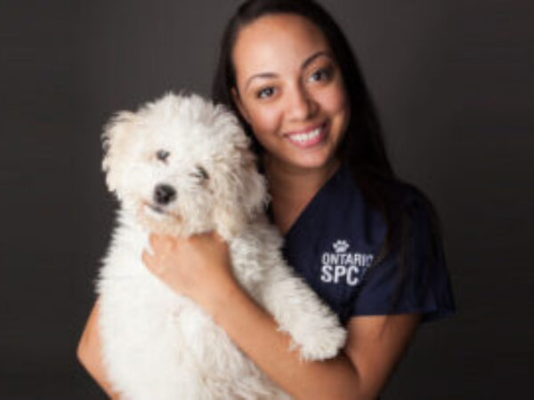 woman holding white dog