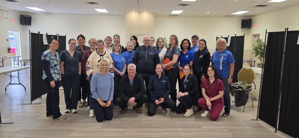 Group shot of volunteers and staff looking at camera